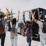 Young People having Fun in front of Tour Bus